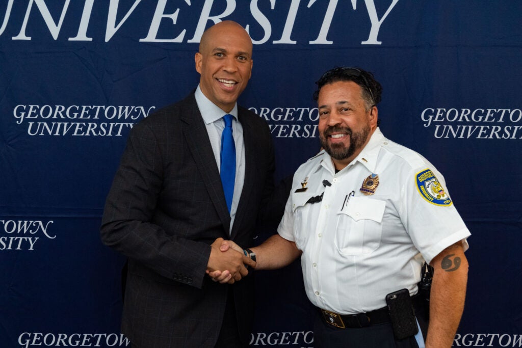 GUPD officer shakes hands for a photo with Senator Cory Booker.